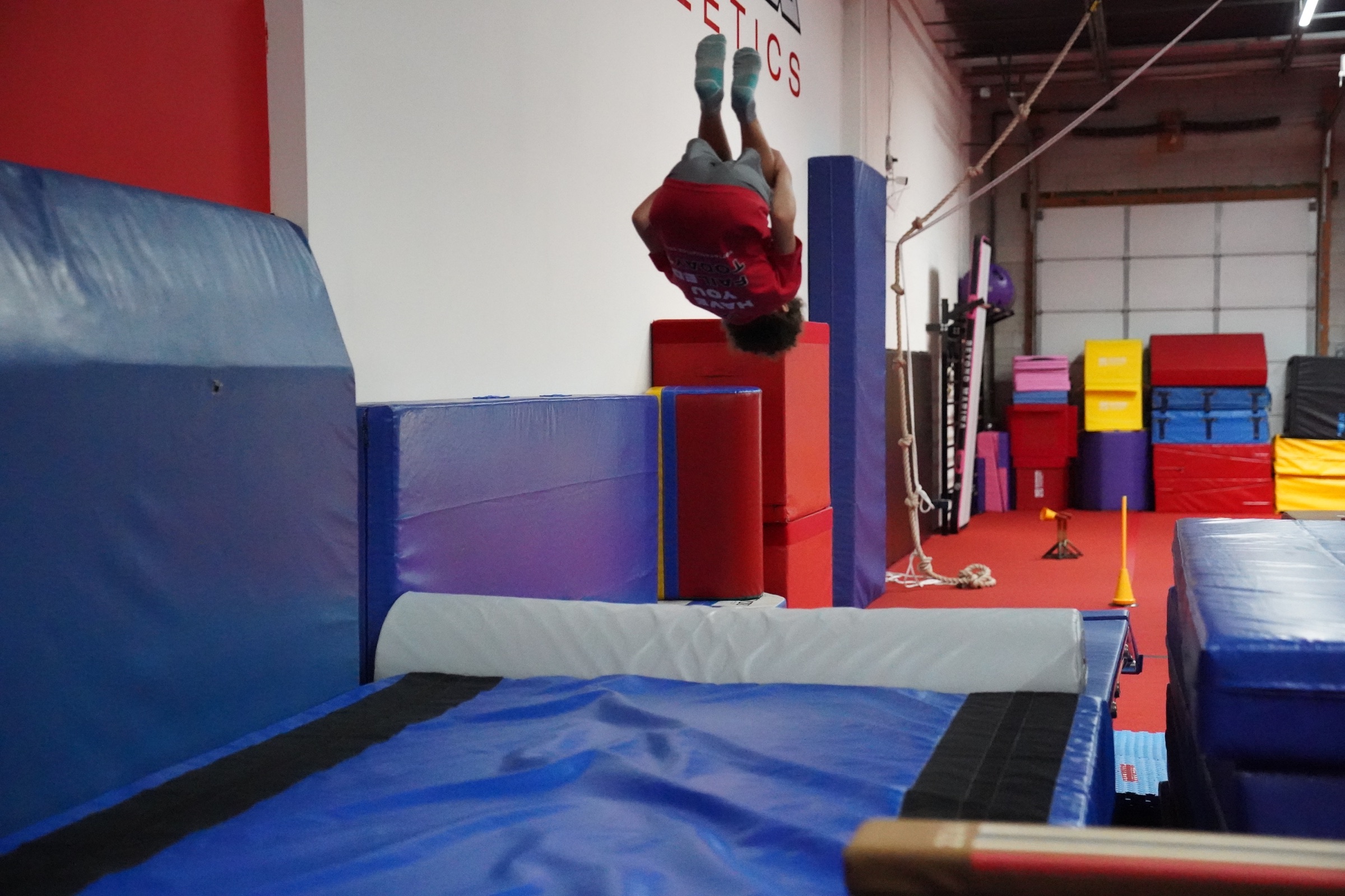 A Vortex athlete performing a skill above the double mini trampoline